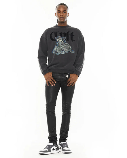 Man wearing a black sweatshirt with graphic design and text, standing against a white background
