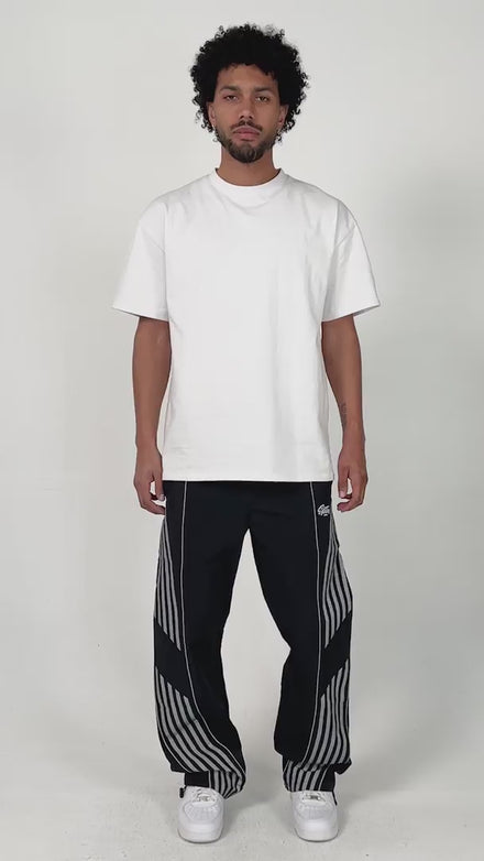 model wearing the black variant of the Roundy pants by the brand EPTM. Chill posing and styling.