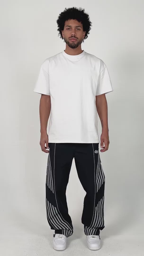 model wearing the black variant of the Roundy pants by the brand EPTM. Chill posing and styling.