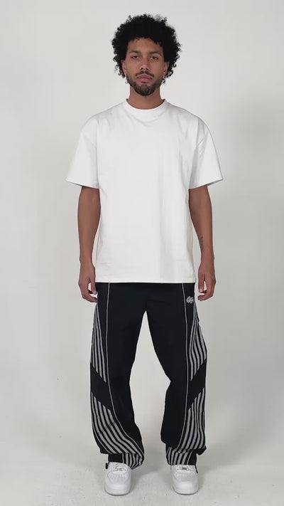 model wearing the black variant of the Roundy pants by the brand EPTM. Chill posing and styling.