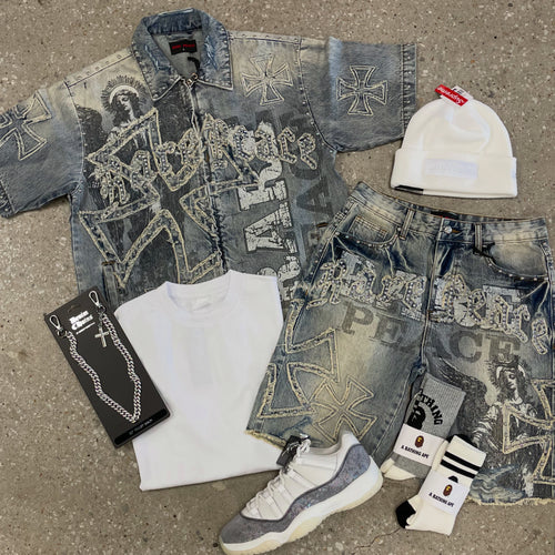 Collection of denim clothing and accessories on a concrete surface