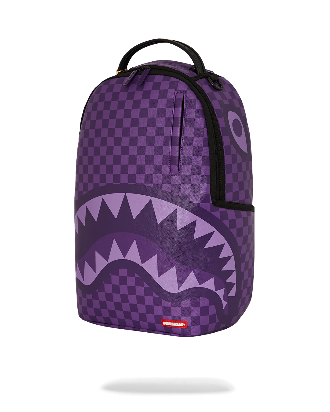 Purple checkered backpack with shark mouth design on a white background by sprayground