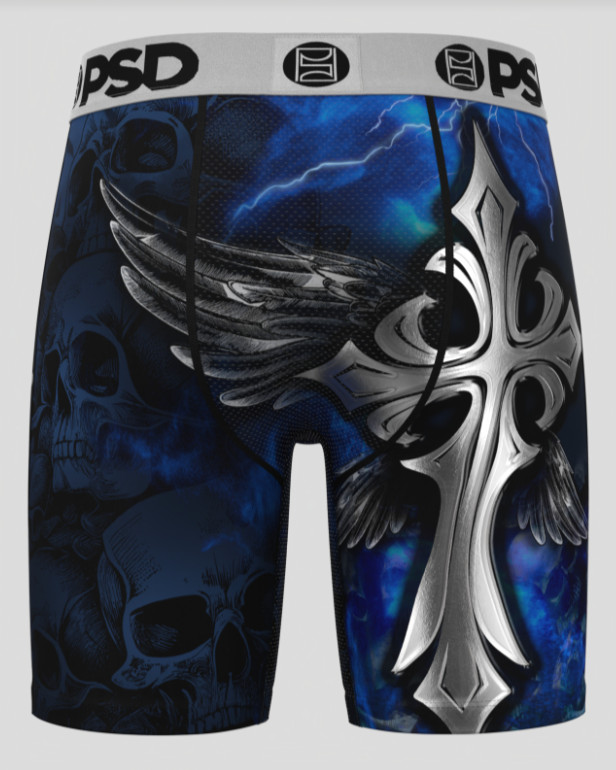 Boxer briefs with a blue and black design featuring wings, skulls, and a cross on a white background.