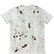 White t-shirt with brown splatter pattern on a white background