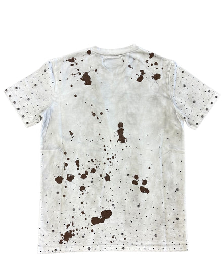 White t-shirt with brown splatter pattern on a white background