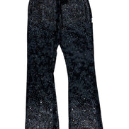 Black flared pants with rhinestone embellishments on a white background
