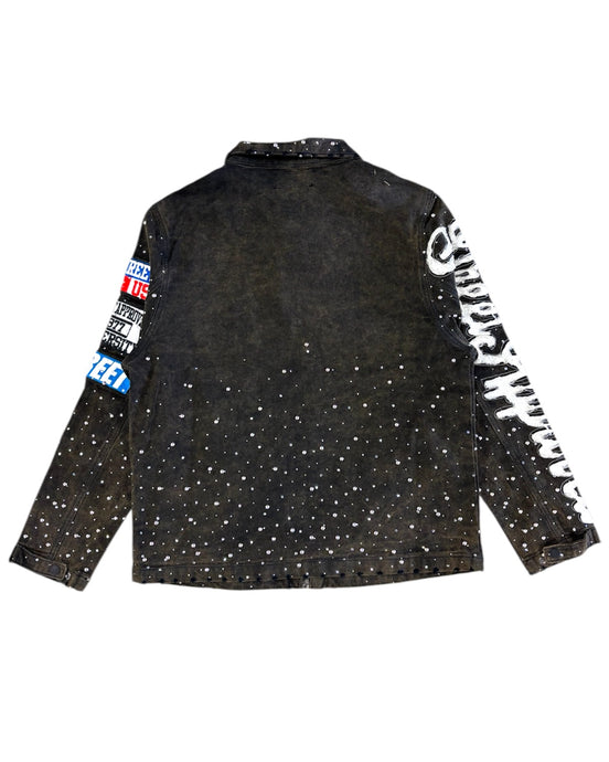 Black jacket with white speckles and branded sleeves on a white background