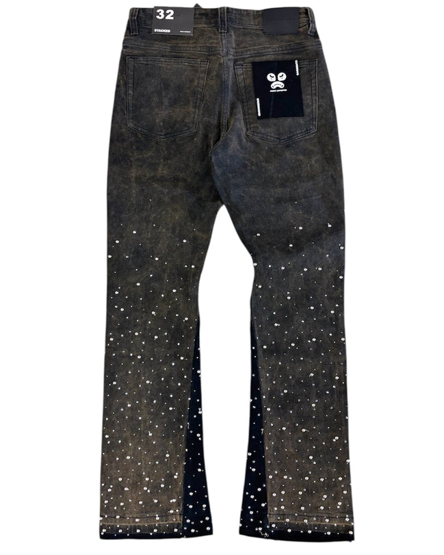 Black jeans with white speckles on a white background