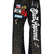 Black jeans with white text and graphics on a white background