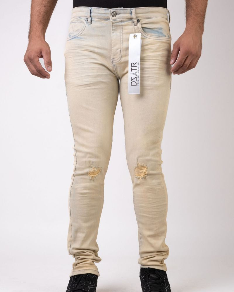 Beige jeans with a visible brand tag on a white background
