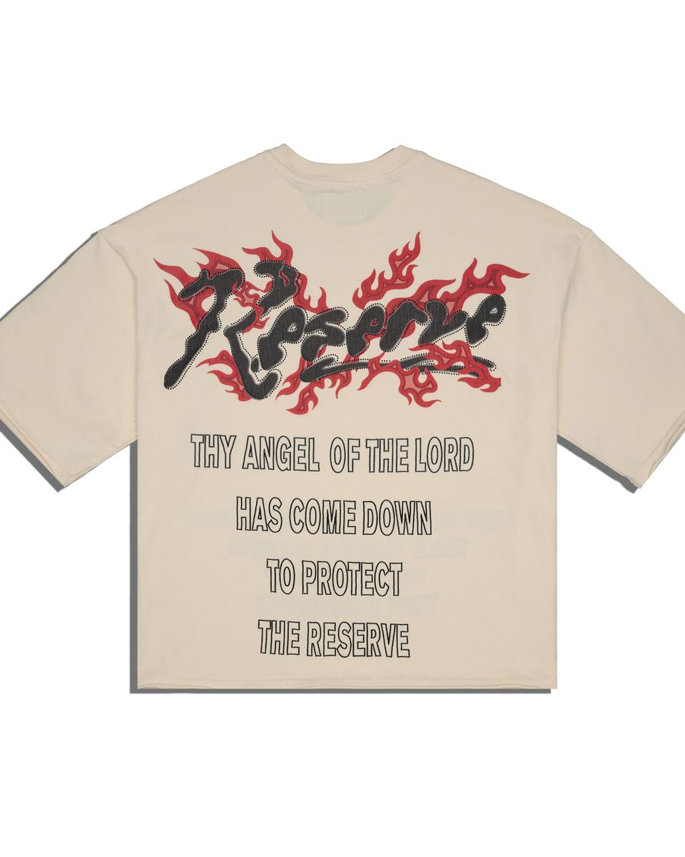 Back of a bone color t-shirt with black and red graphic design and text on a white background 