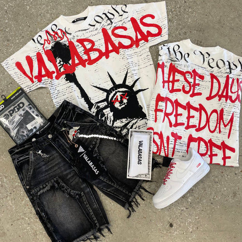 Fashion items including t-shirts, jeans, and sneakers with visible branding on a concrete surface.